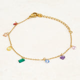 Rainbow pride bracelet featuring droplets with colours from the rainbow pride flag, wide