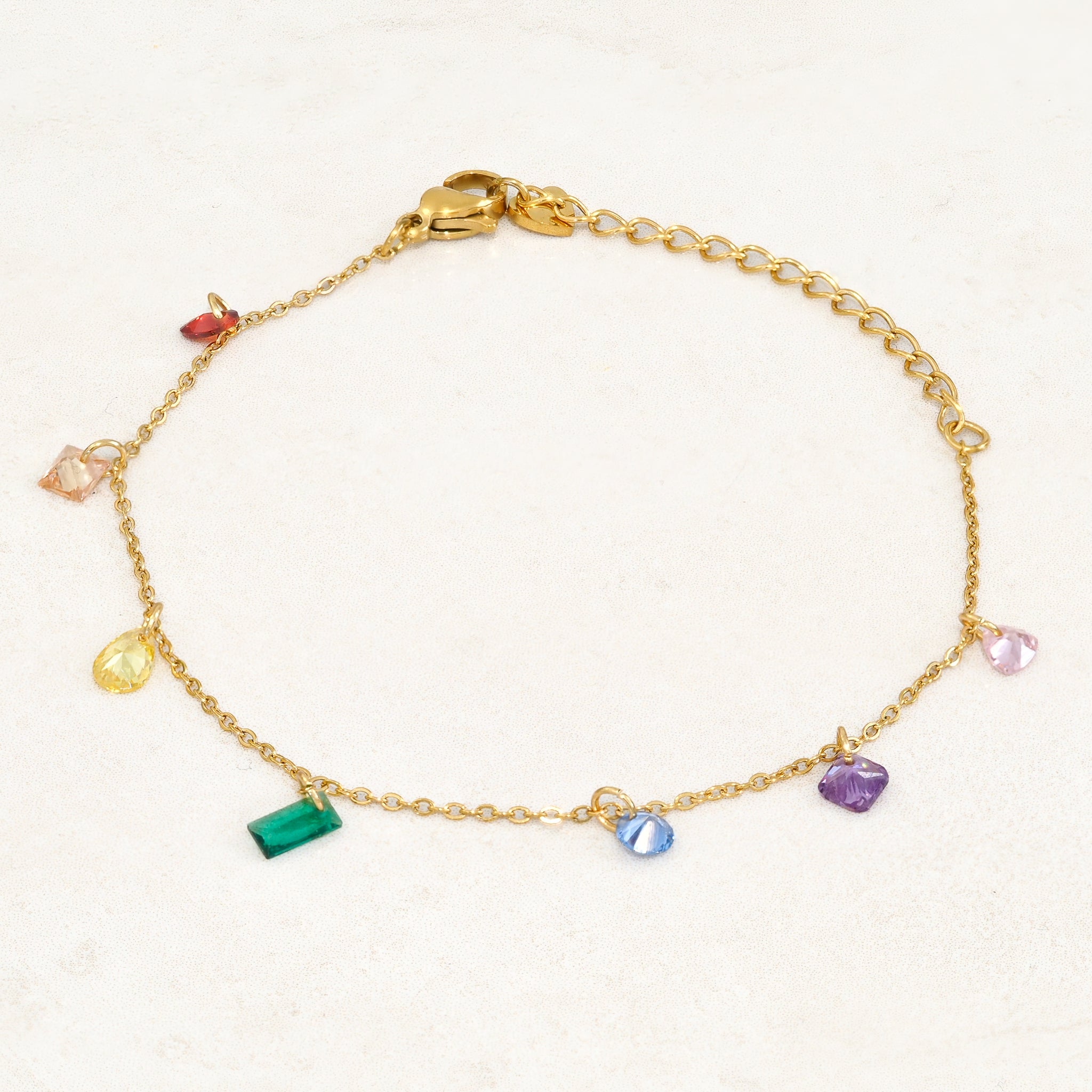 Rainbow pride bracelet featuring droplets with colours from the rainbow pride flag, wide