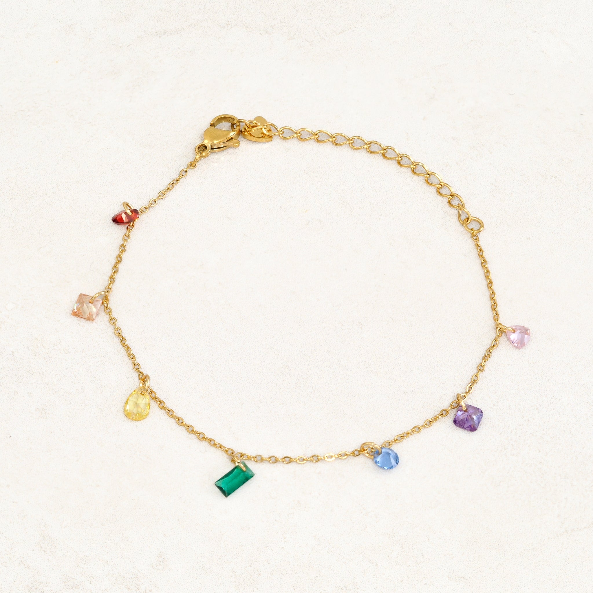 Rainbow pride bracelet featuring droplets with colours from the rainbow pride flag, wide view