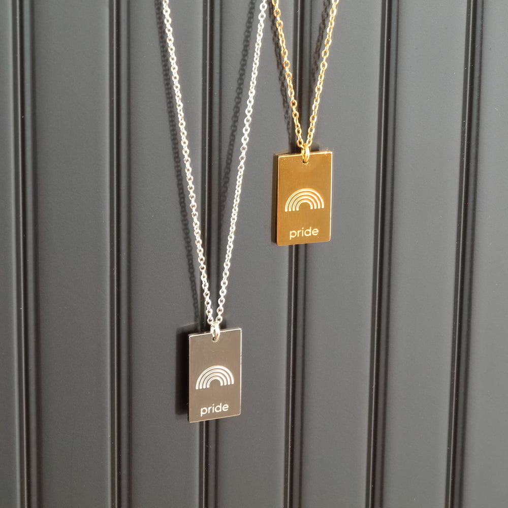 pride tag necklace with rainbow symbol and pride text in pride jewellery collection, black background