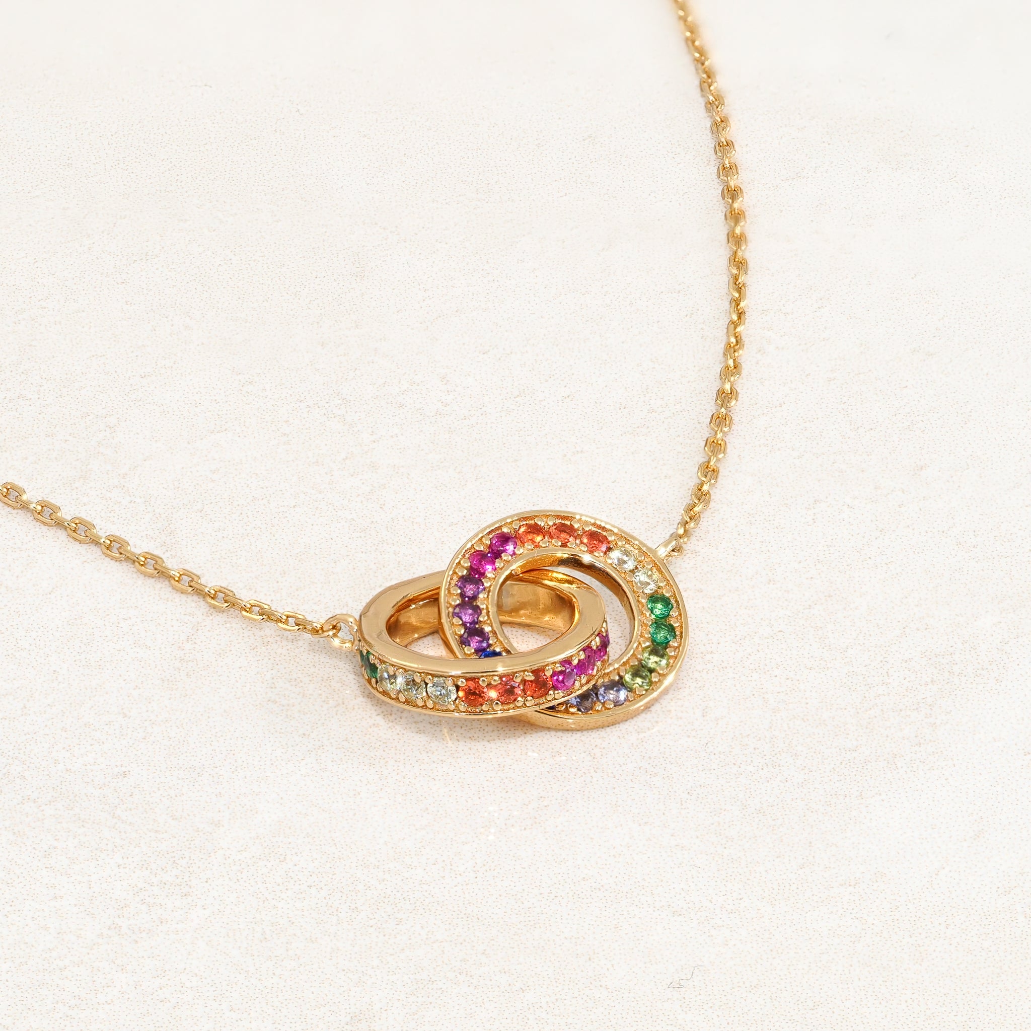 Rainbow Necklace featuring double ring elements and the colours of the rainbow LGBT pride flag, left