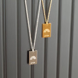 pride tag necklace with rainbow symbol and pride text in pride jewellery collection, black background